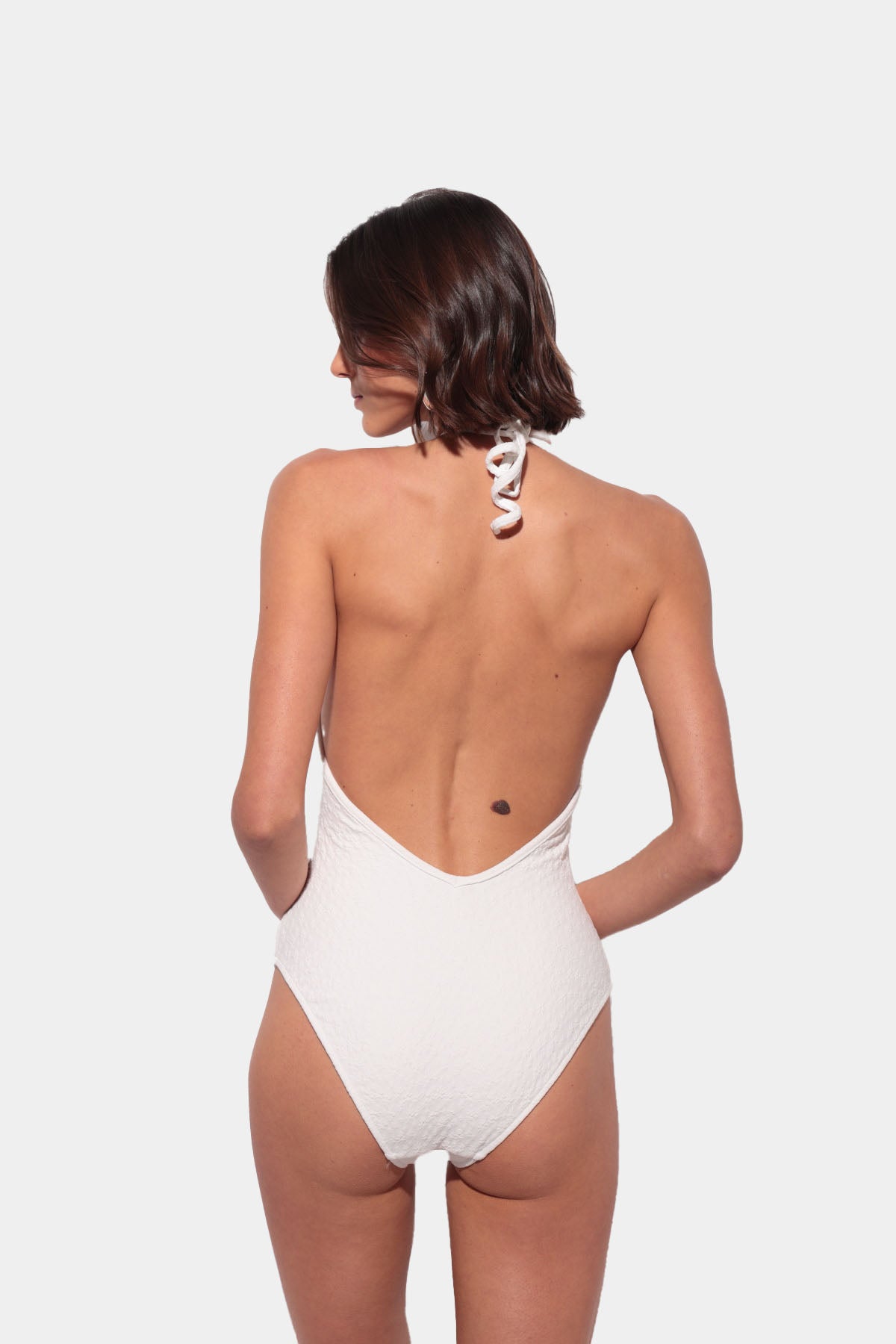 White swimsuit with a V-neck and low back
